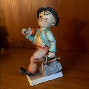Charming Figurine with Blue Jacket and Gray Hat